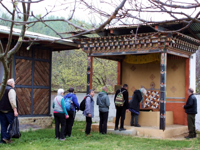 Kybje Dilgo Khyentse Rinpoche Throne. Sangha members pay respects at the throne of Kyabje Dilgo Khyentse Rinpoche. Bhutan, March 2016.
