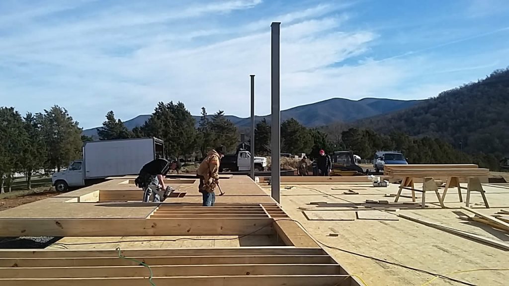 12 JANUARY&mdash;Workers build the walls lying flat. They will be raised by crane when completed.