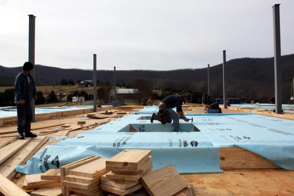 13 JANUARY&mdash;Workers apply Tyvek wrap to allow vapor to escape and to prevent rot and mold inside walls.