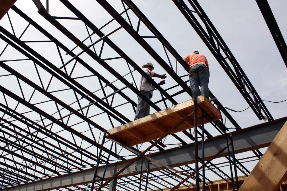 5 APRIL&mdash;Workers securing sections of metal joists for the second floor.