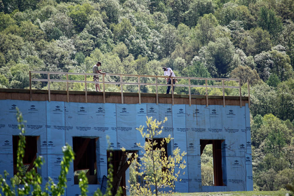 25 APRIL—Workers construct a safety/wind barrier in preparation for work on the second story of the temple.