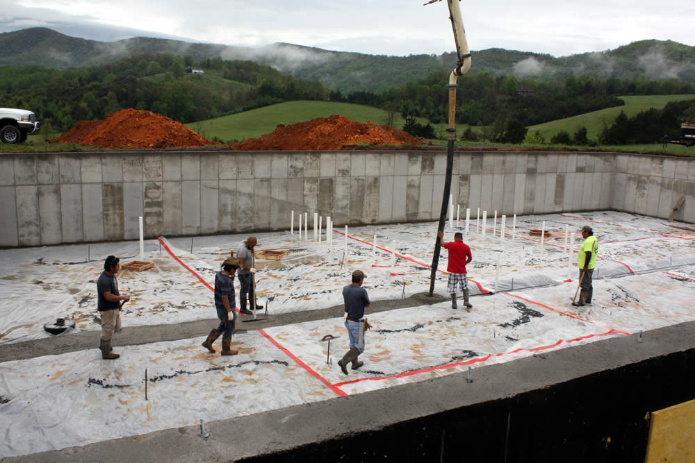 MAY 2-Workers pouring concrete for the footer which will provide the main central support wall for the temple.