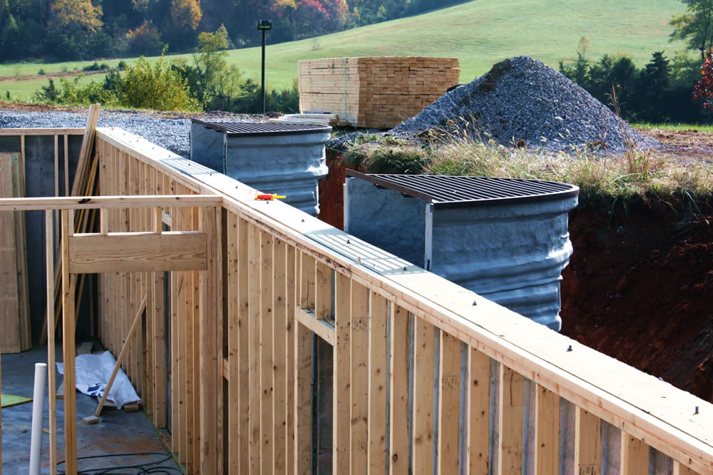 Window-well positioning complete, allowing emergency exit from the temple basement. The grates will open on to the surrounding wooden deck.